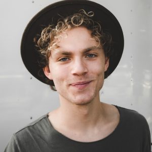 man standing near white wall